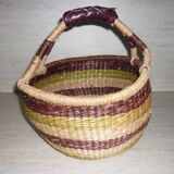 Round and colorful straw basket with handles