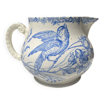 Earthenware pitcher decorated with birds.