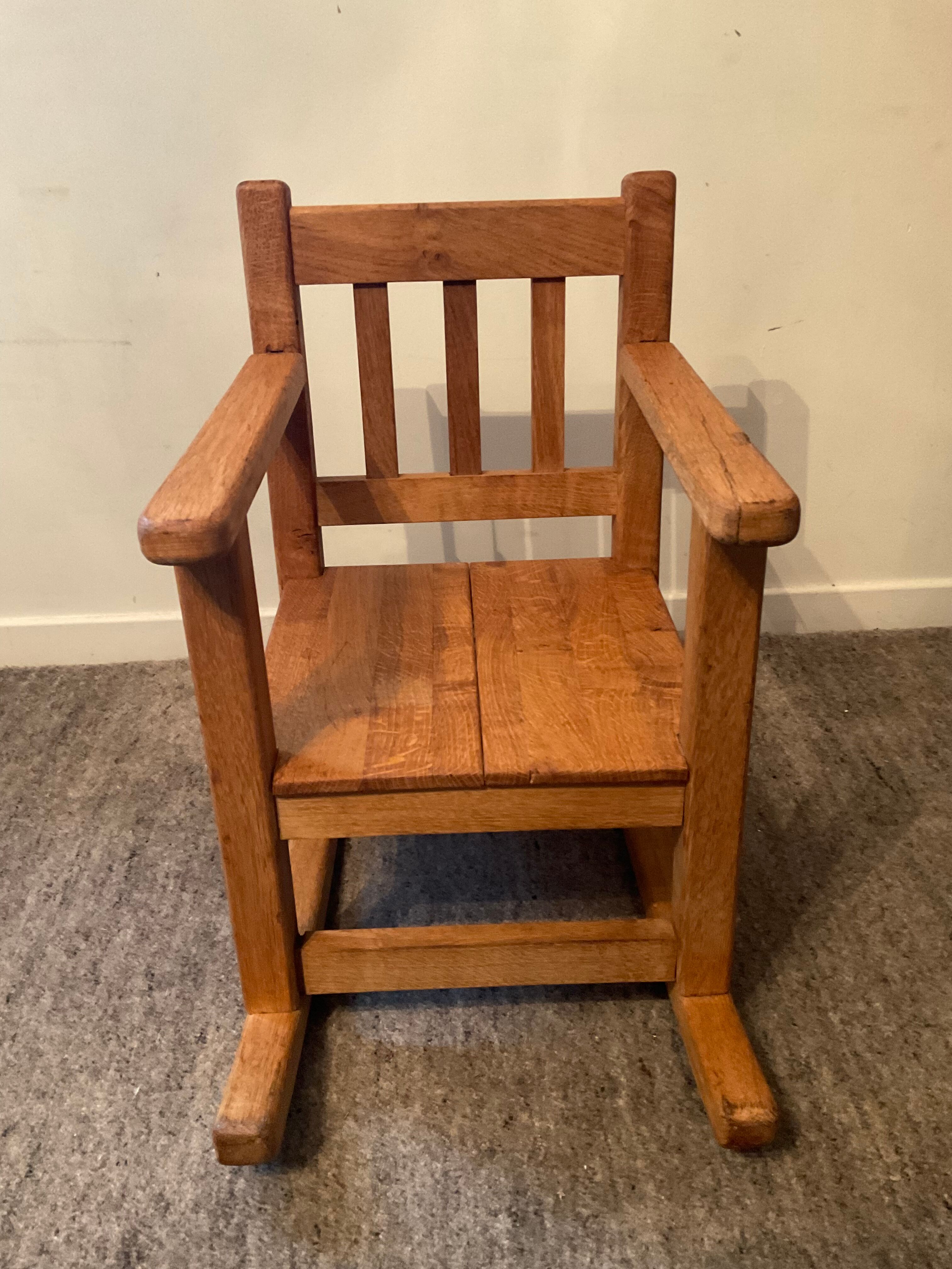 Old children's rocking chair in solid wood