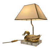 Vintage brass table lamp in the shape of a duck from the 1970s on an acrylic base.