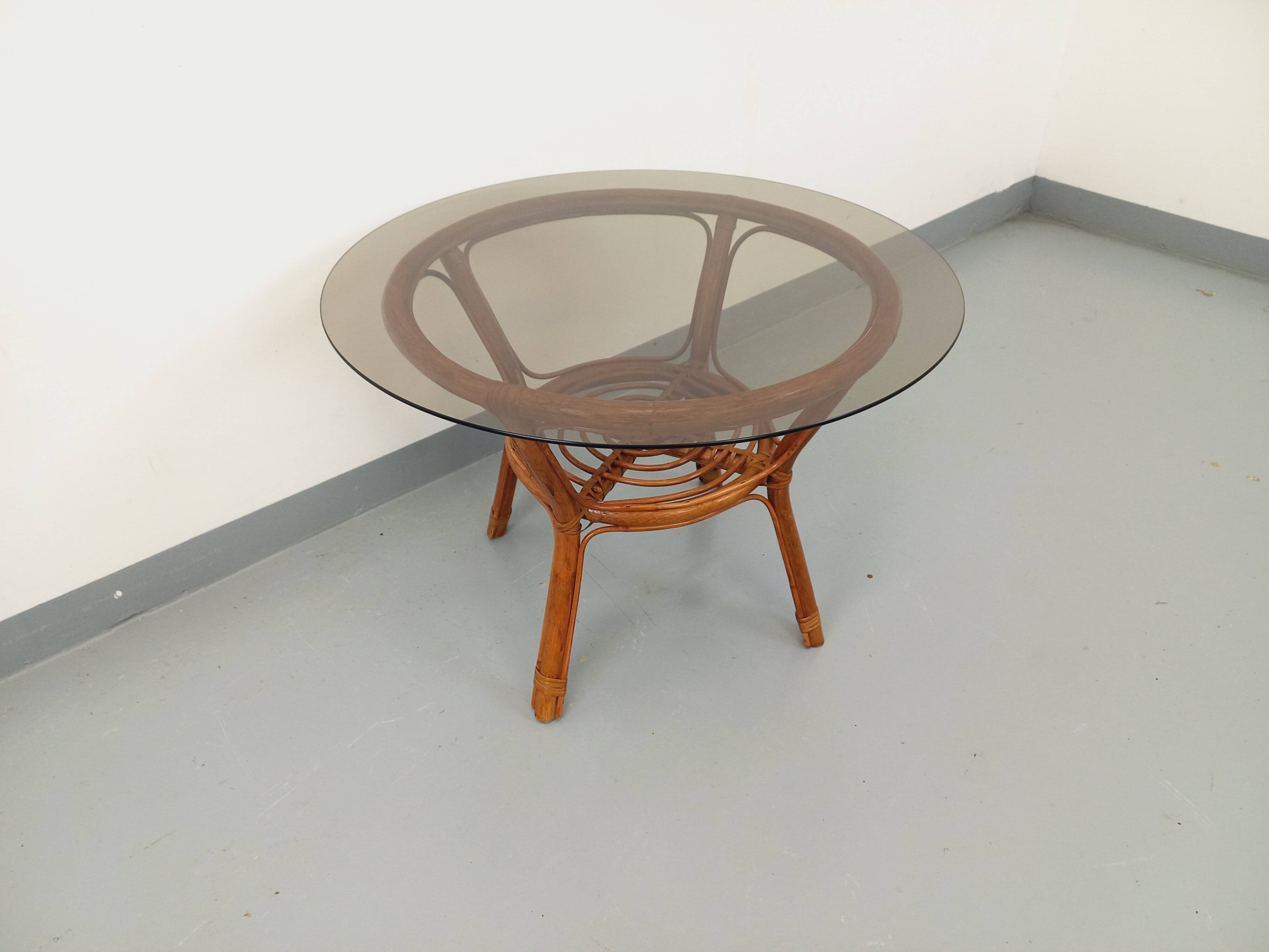 Vintage round smoked glass and rattan coffee table from the 70s