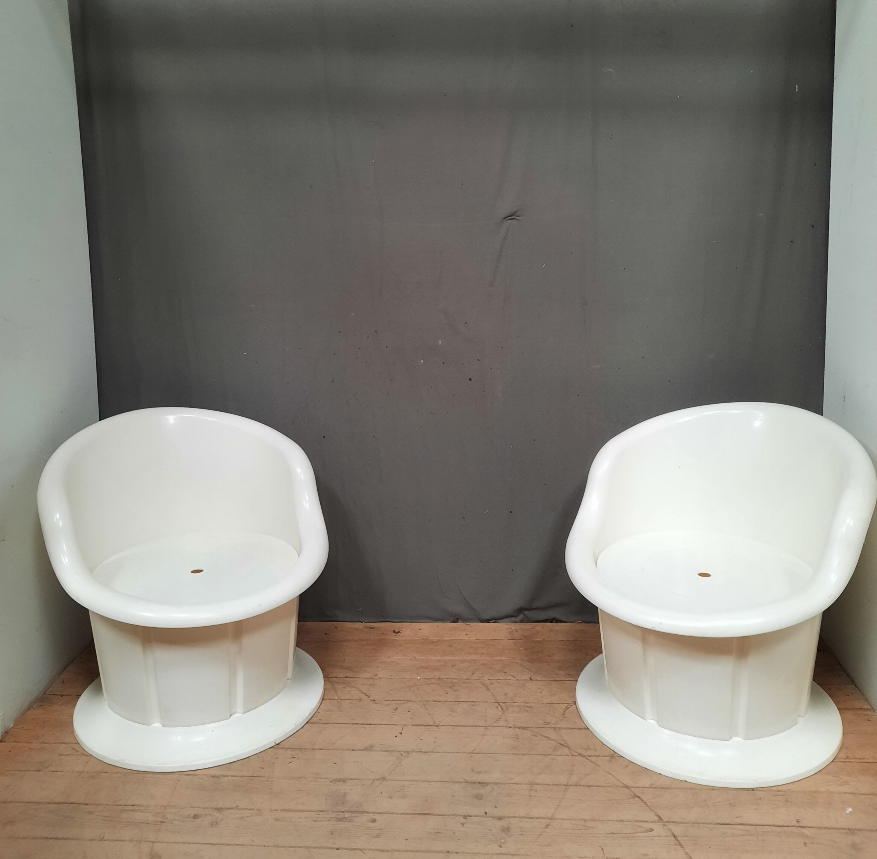 Pair of white plastic armchairs