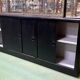 Store window with sliding doors in matte black patinated oak - 30s