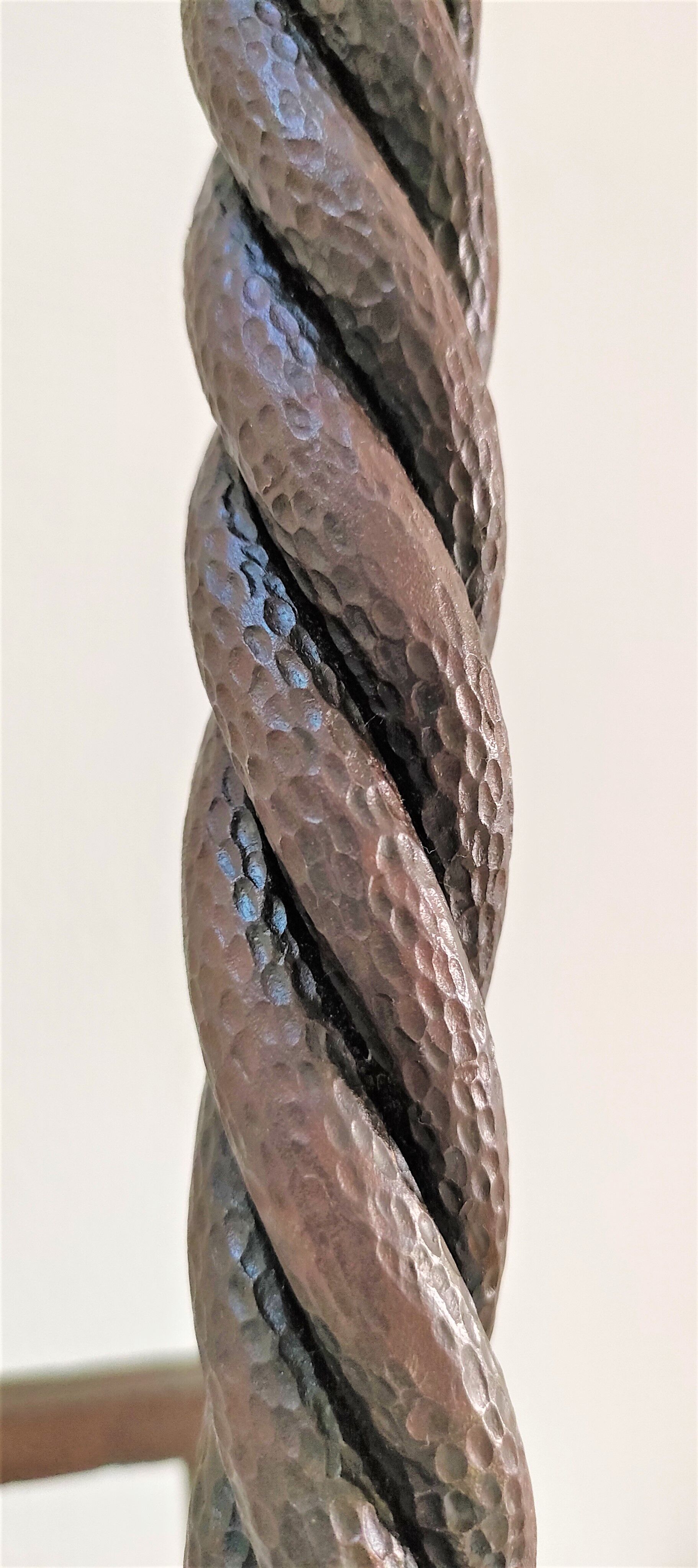 Pair of sculptural cast iron chenets with twisted heads