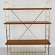 String wall shelf in gold metal and wood from the 60s