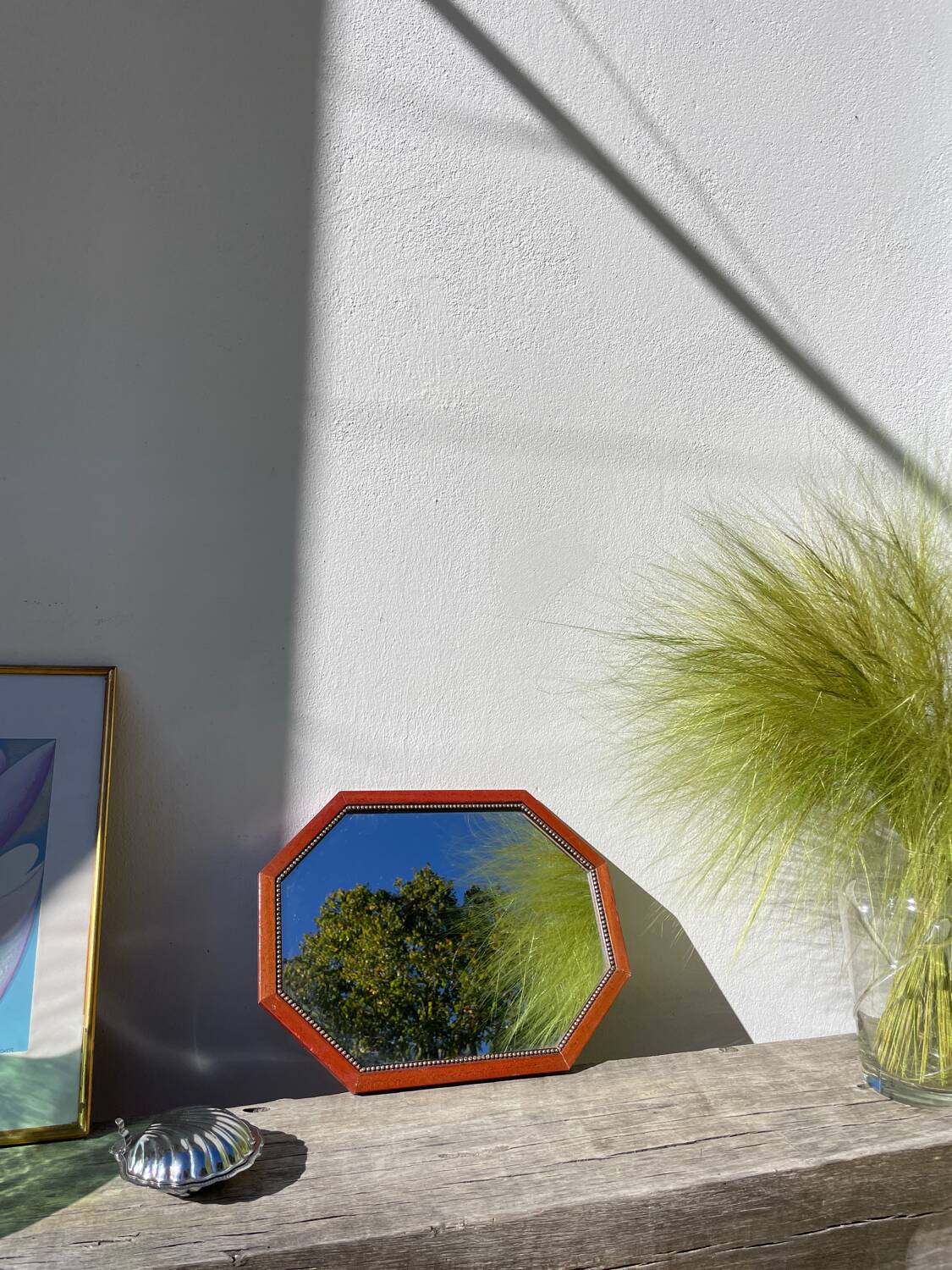 Octagonal beaded wooden mirror