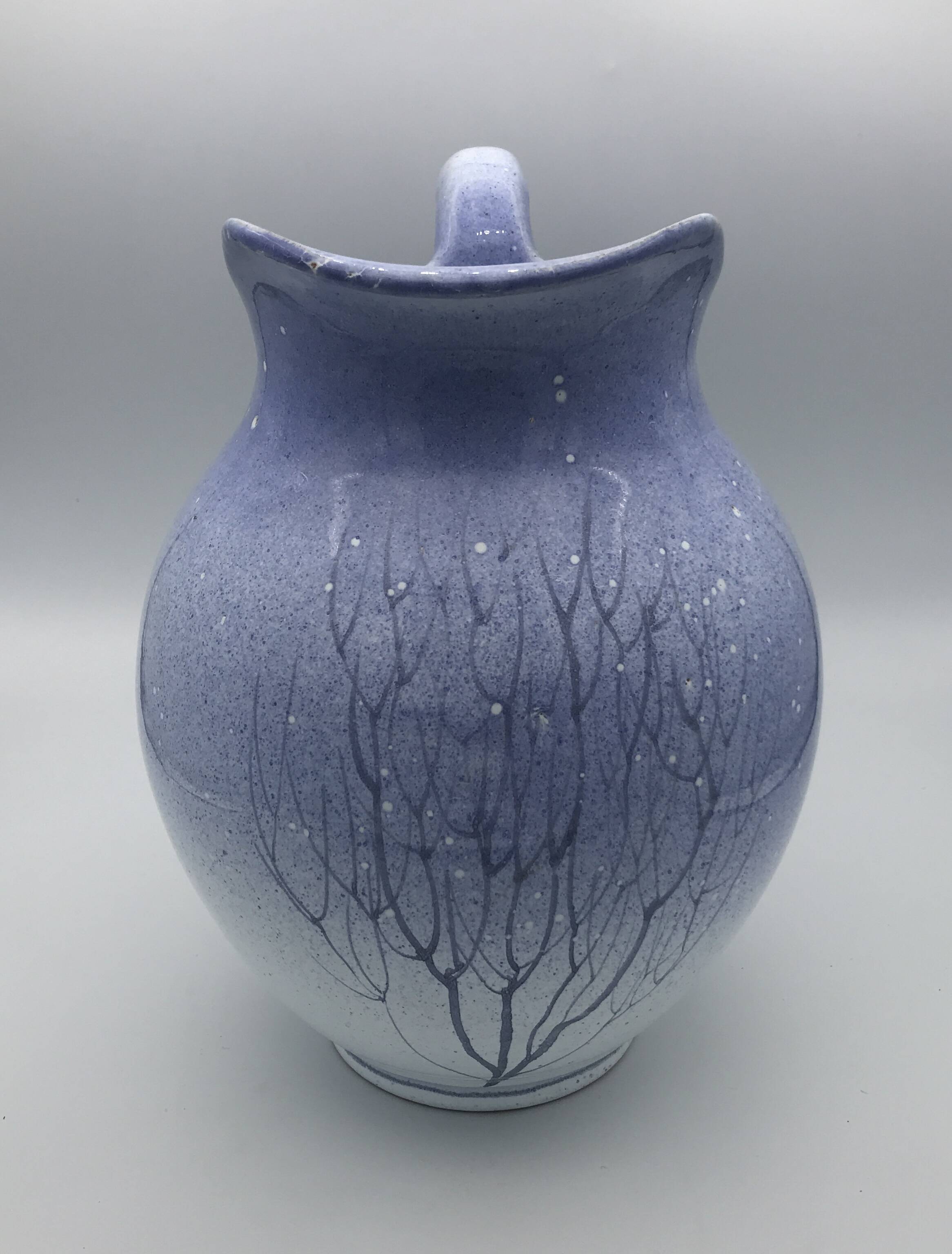 Blue glazed terracotta pitcher with hand-painted decoration, signed
