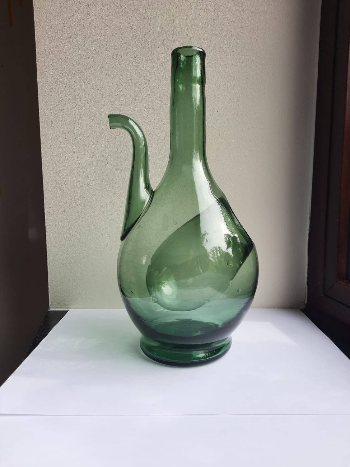 Pair of blown glass wine decanters in blue/green hues.