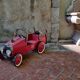 Old pedal car in tole fire truck