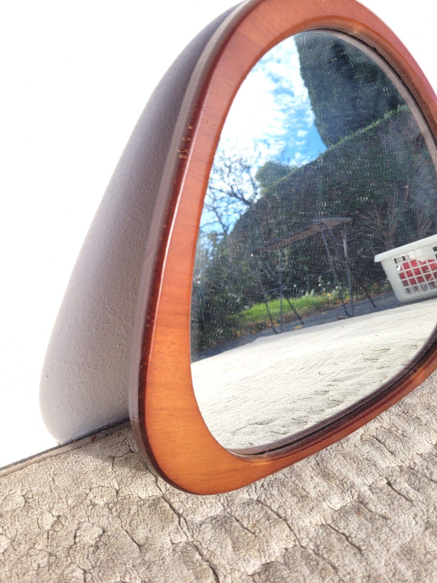 Contemporary oval mirror in teak finish