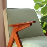 Vintage armchair in mint green wool, mid-century modern design.