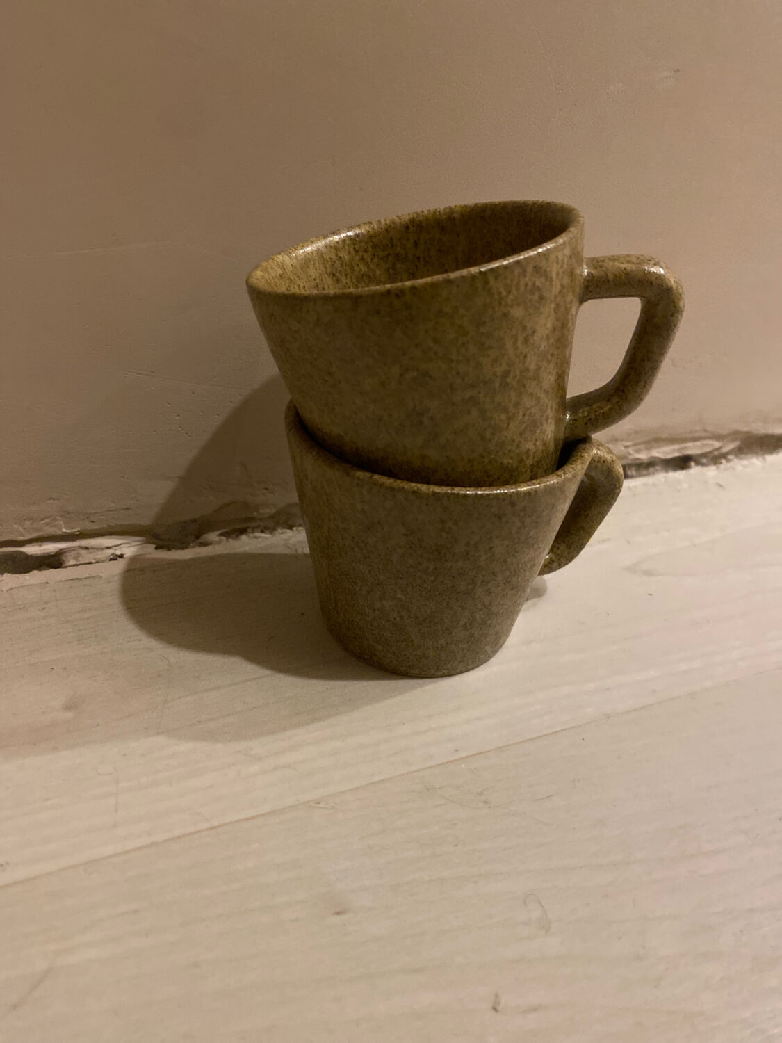 Set of stoneware coffee cups with saucers.