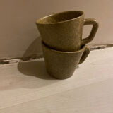 Set of stoneware coffee cups with saucers.