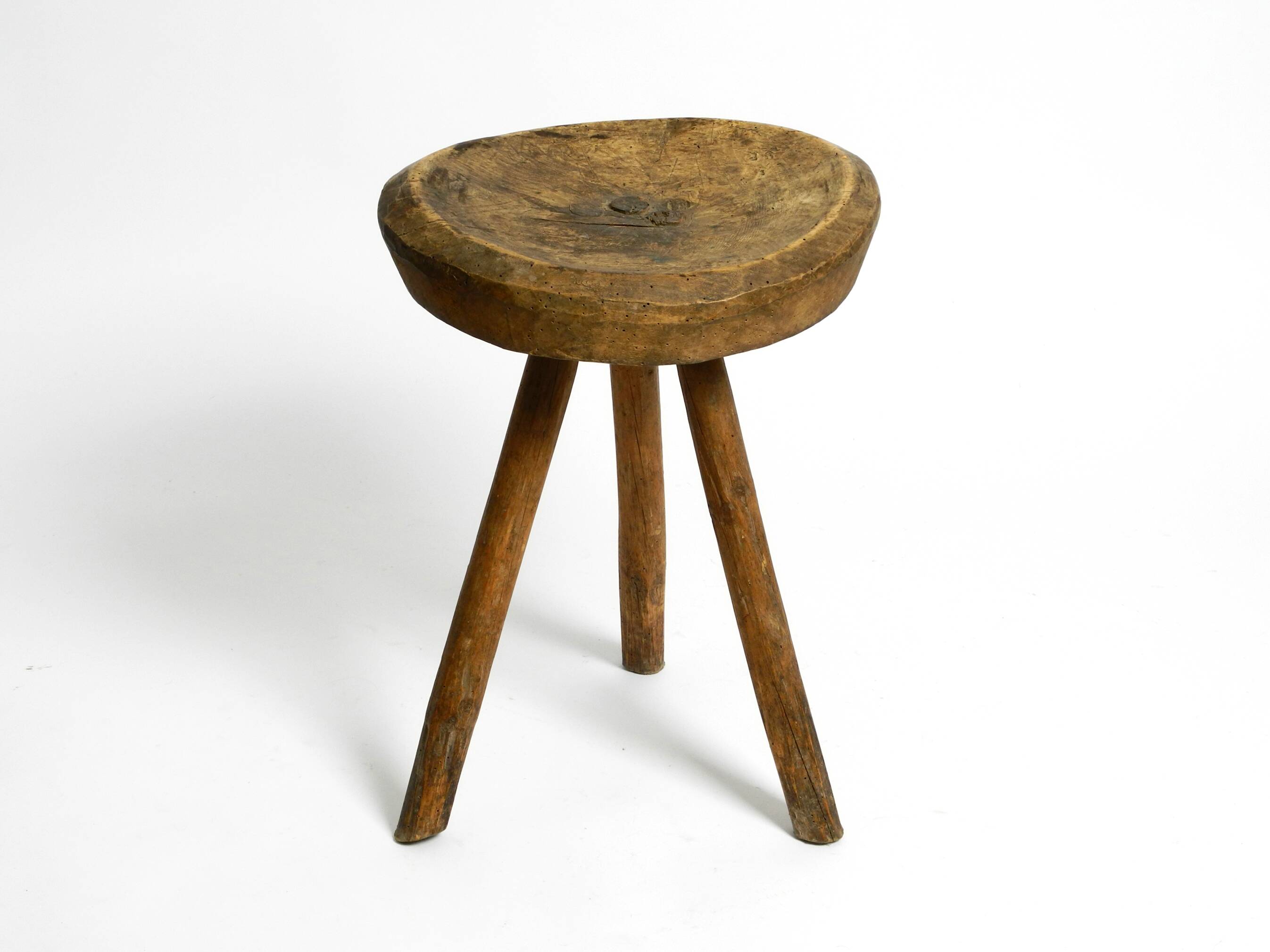 Tabouret en bois massif à trois pieds, sculpté à la main des années 1900, avec une patine fantastique.