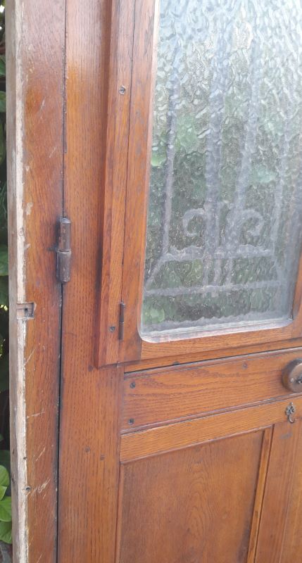 Oak entrance door and its frame and transom, wrought iron gates