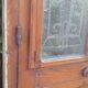 Oak entrance door and its frame and transom, wrought iron gates