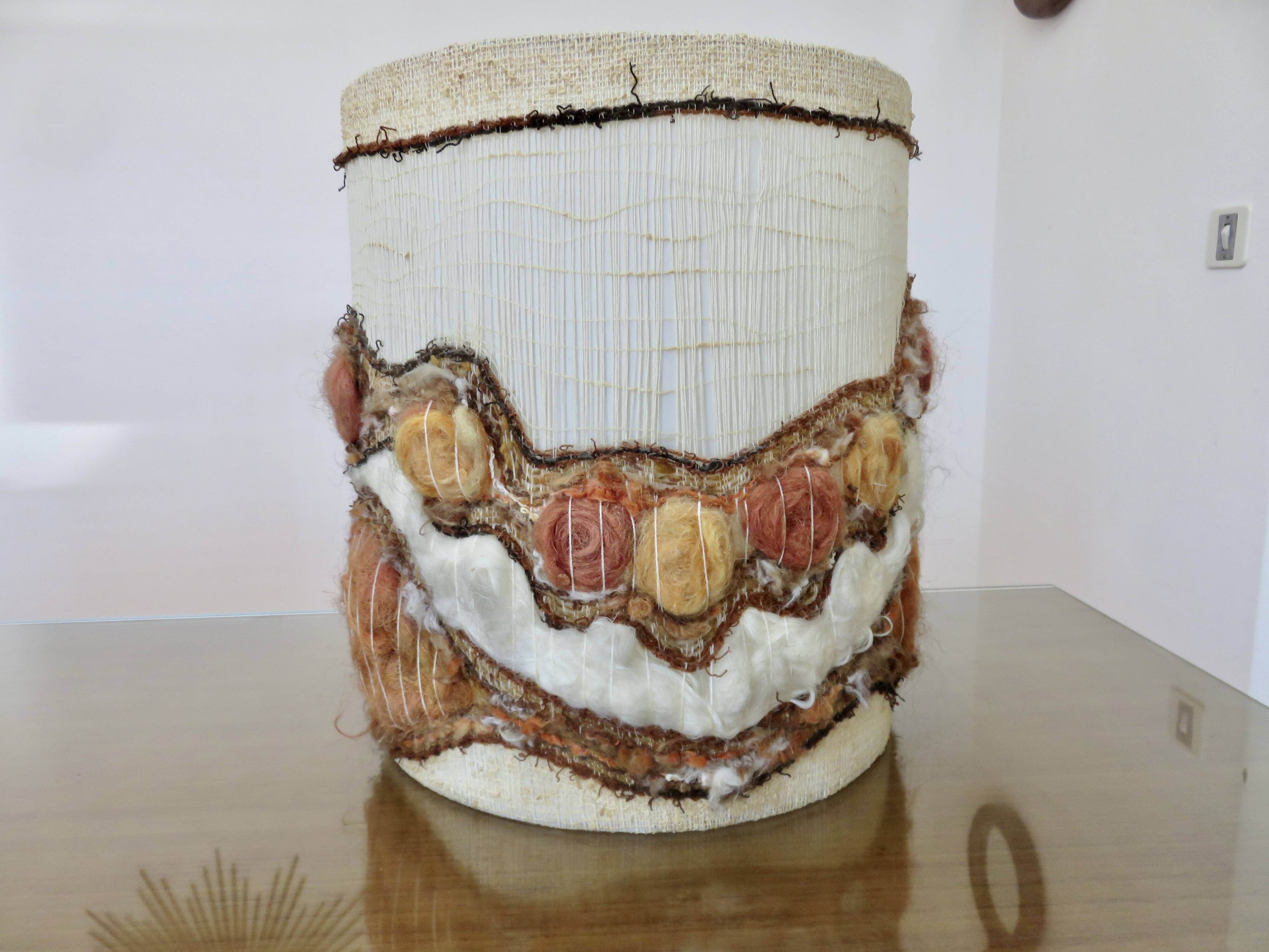 Ceramic lamp with double lighting and openwork design.