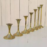 Seven candle holders in golden brass vintage trend