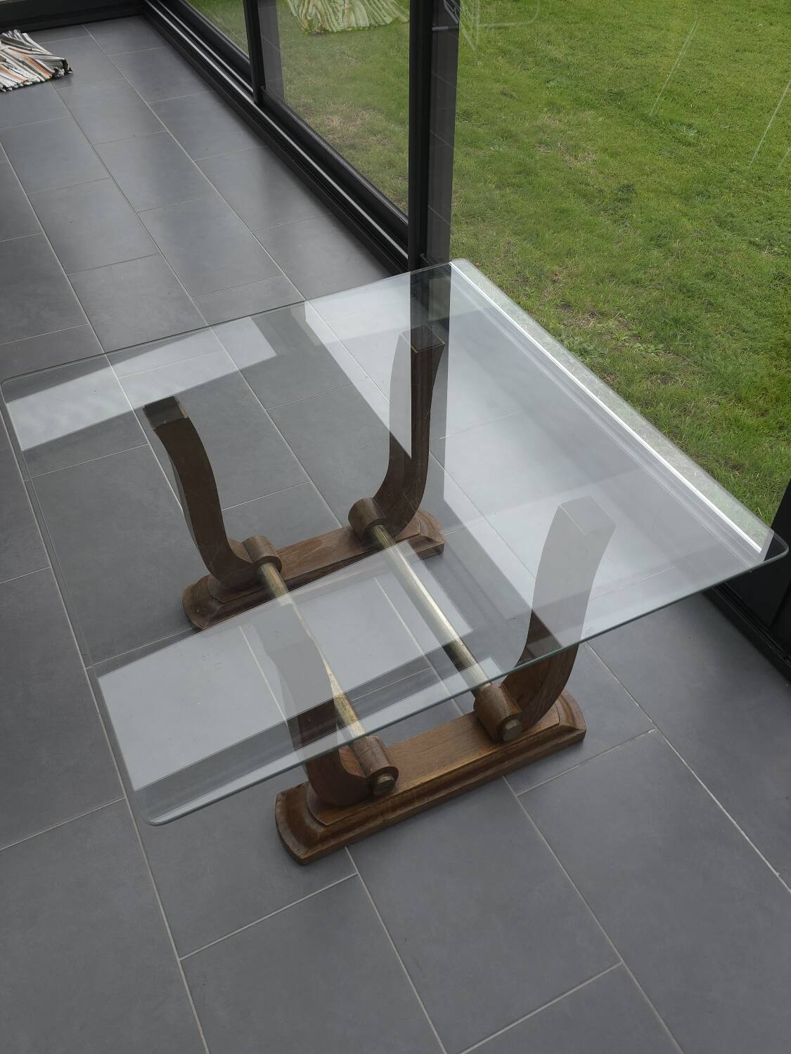 Art Deco coffee table in glass, wood, and brass.