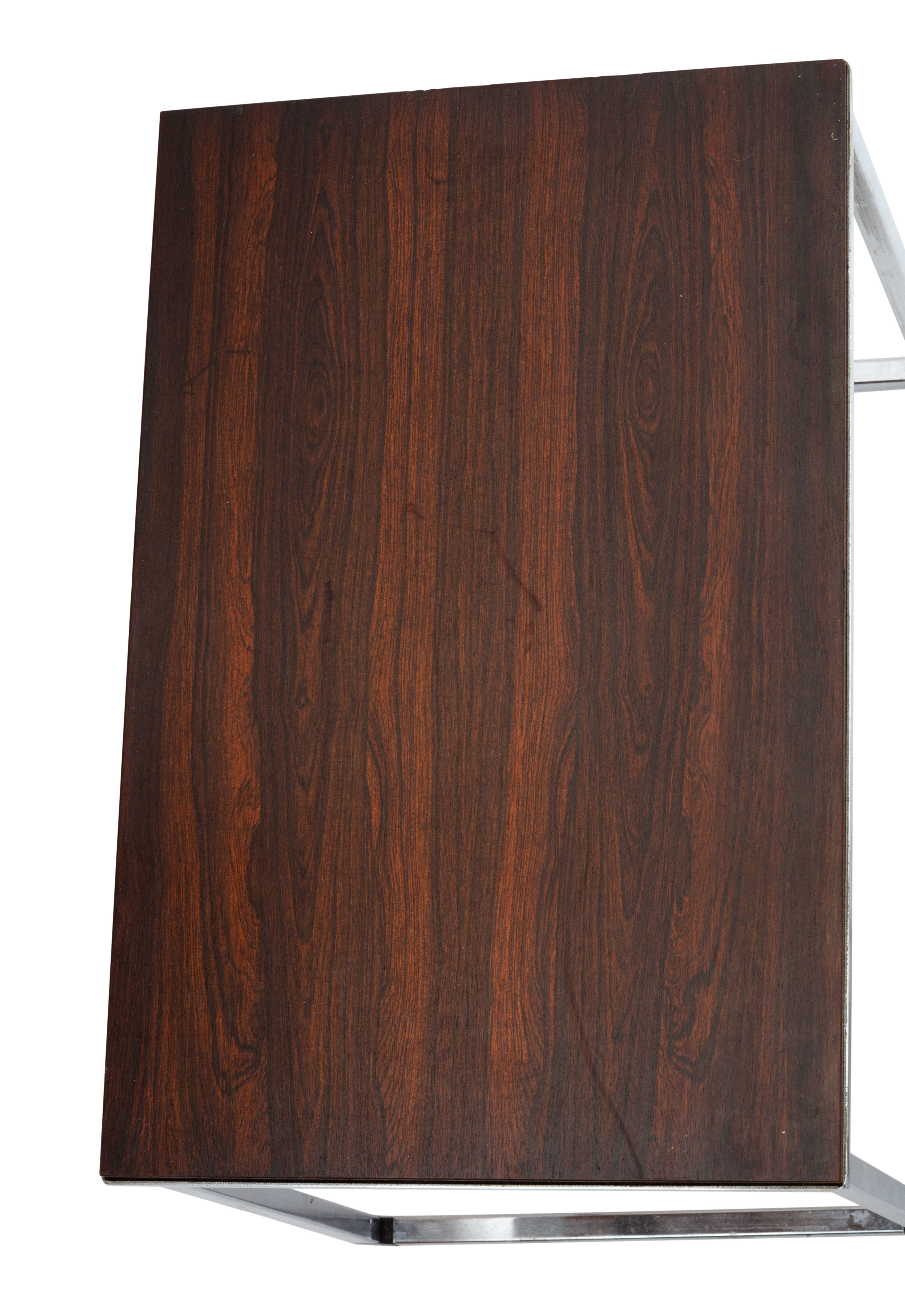 Vintage nesting table in rosewood and high polished metal base.
