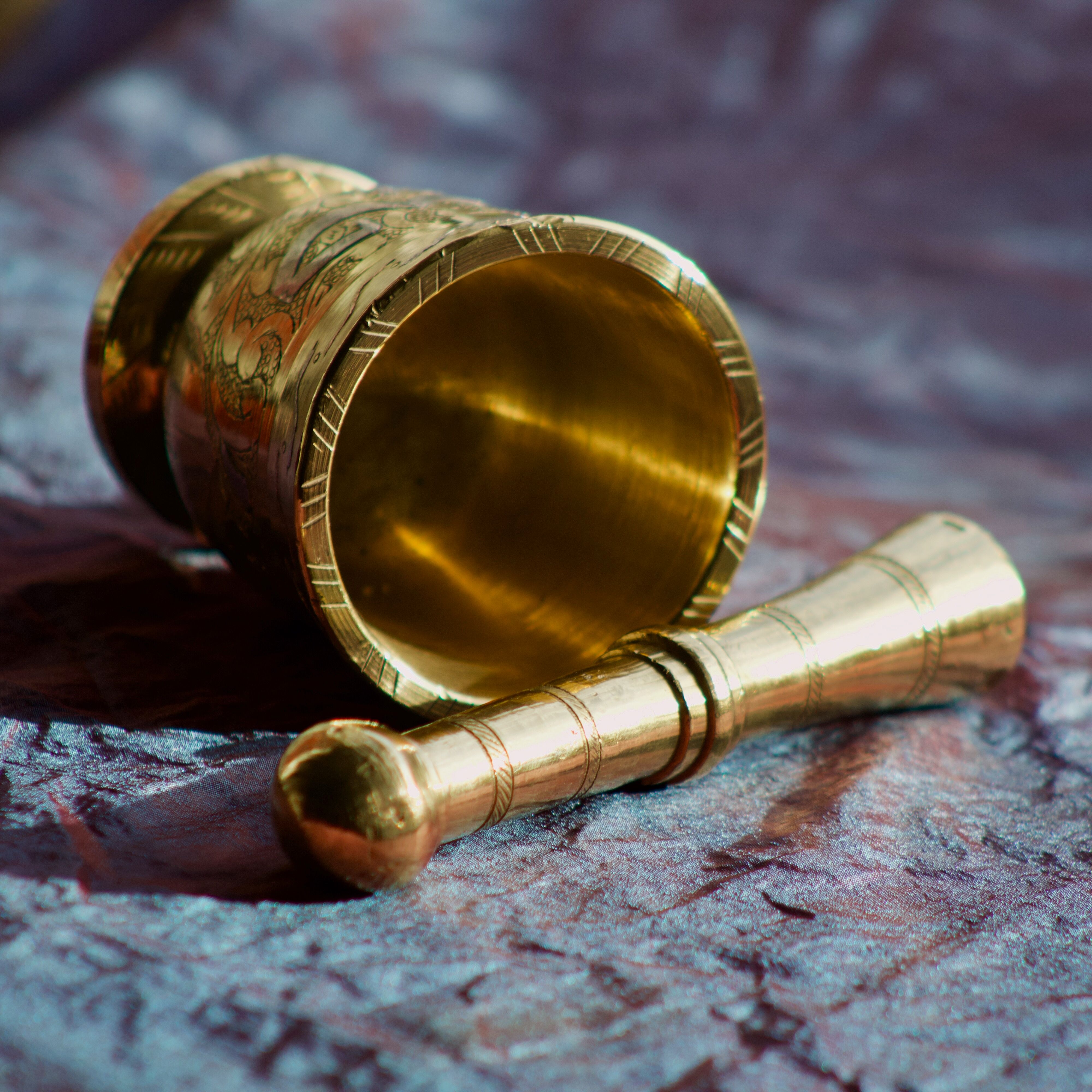 Mortar and its brass pestle with oriental gold and silver motifs