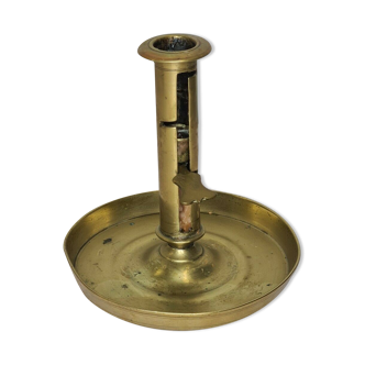 Candle holder with a brass pusher