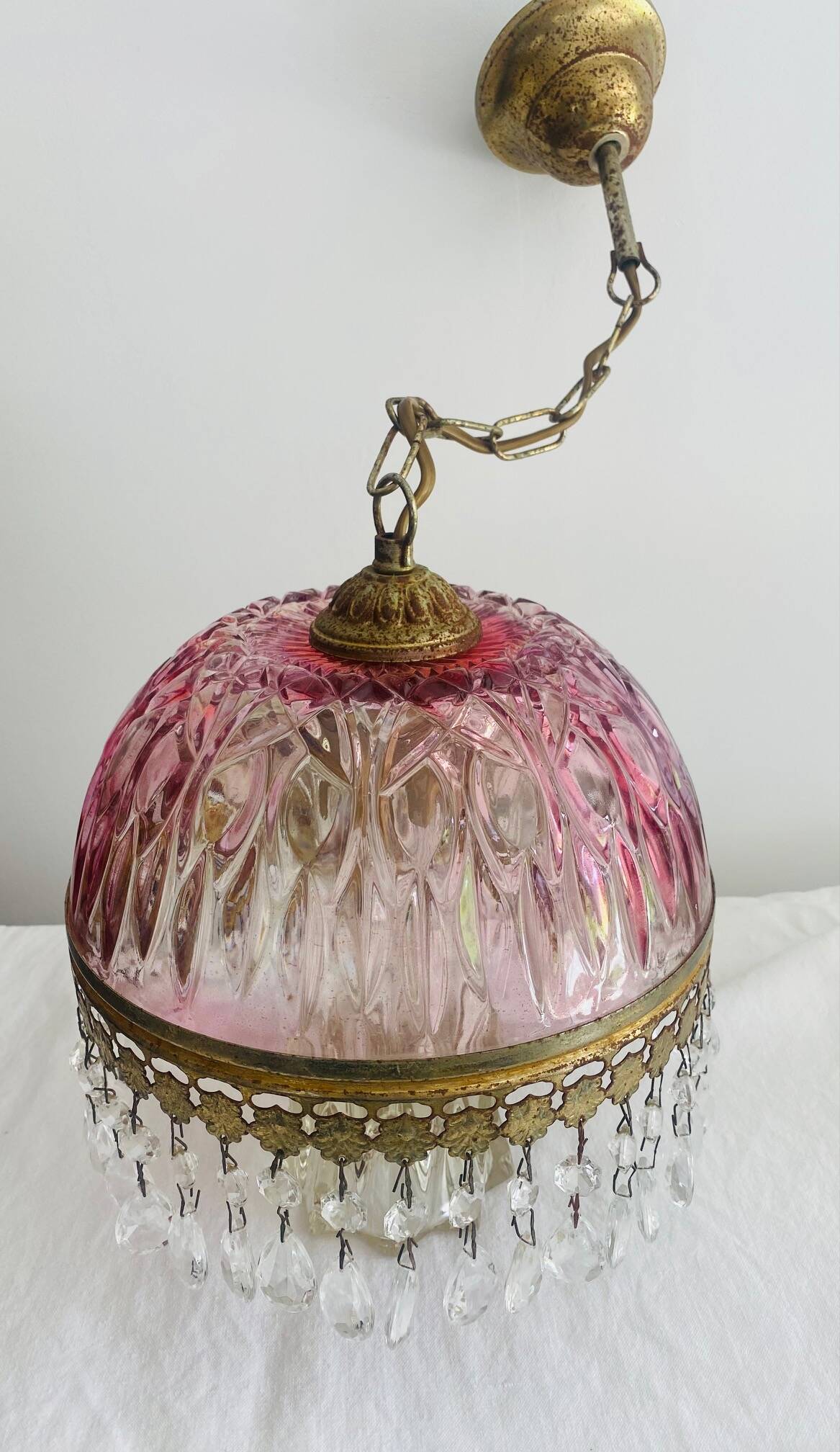 Antique pink glass pendant light with tassels.