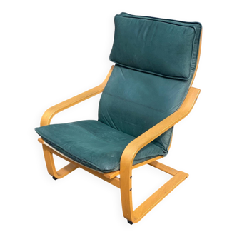Scandinavian rocking chair with curved wood and green leather, IKEA Poäng.
