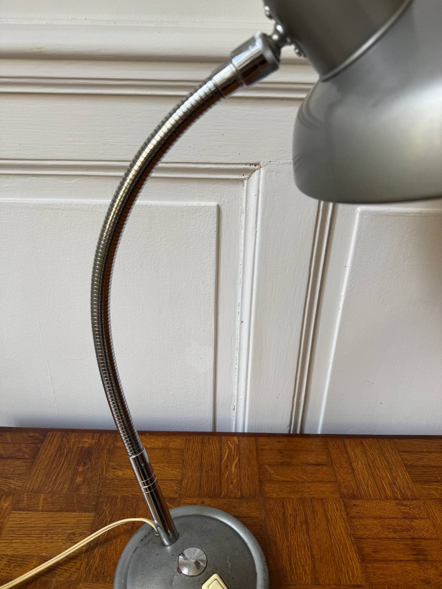 Industrial metal workshop lamp with a gooseneck.
