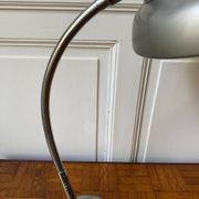 Industrial metal workshop lamp with a gooseneck.