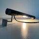 Minimalist black metal wall light with a cylindrical design, 1960s, Germany.