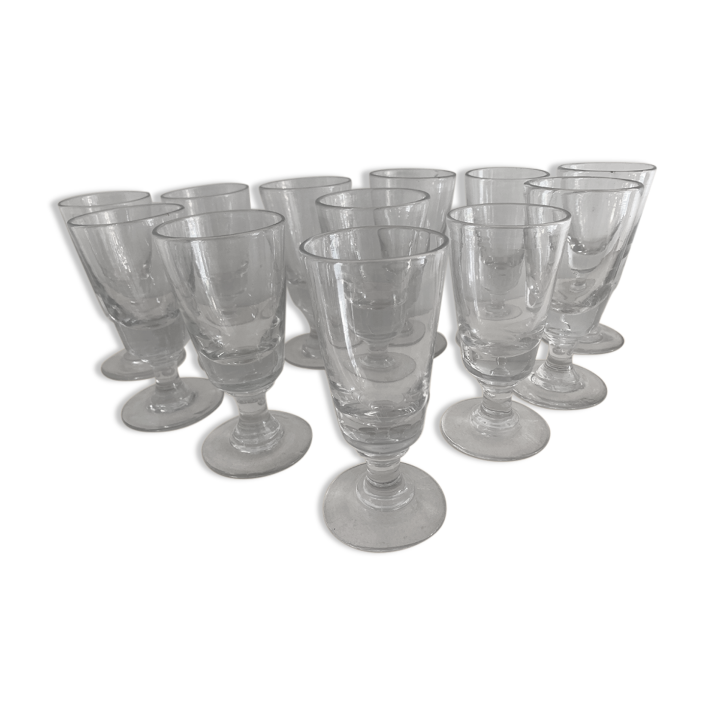 12 old glasses on foot at bistro or absinthe