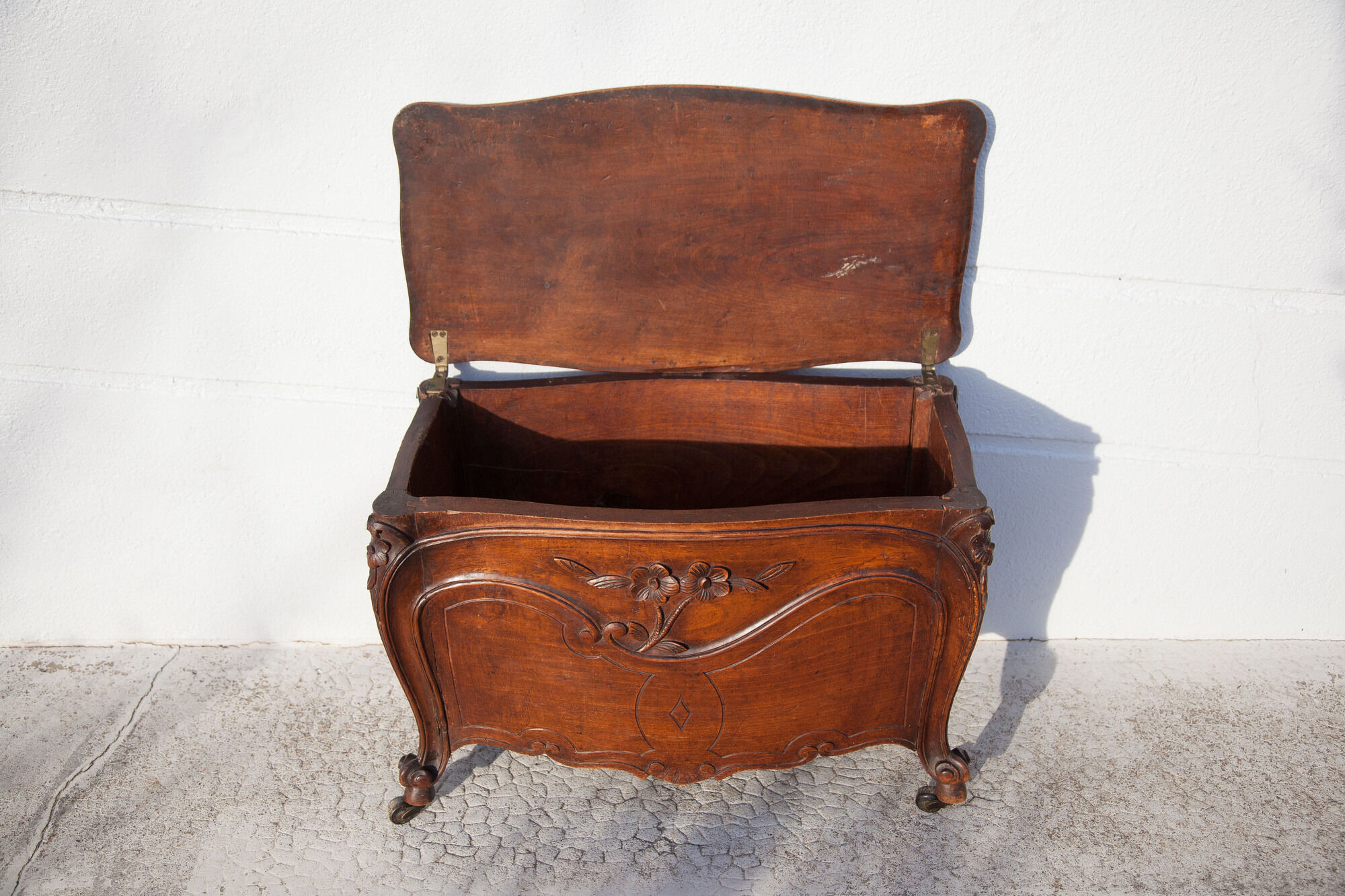 Old chest, carved wooden chest, curved chest on wheels, interior decoration