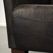 Cow leather Aviator design armchair in a dark colour scheme