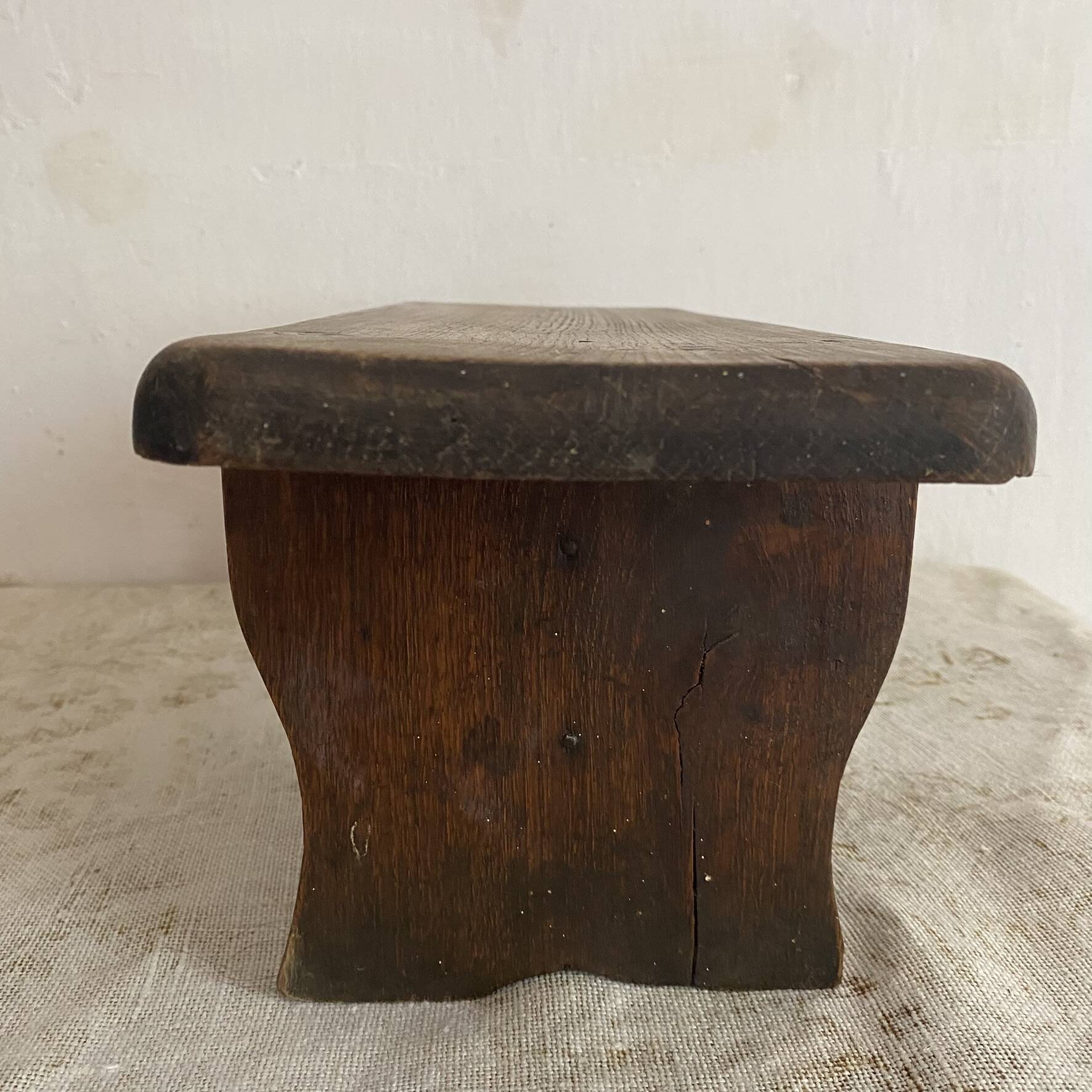 Old low stool made of solid wood