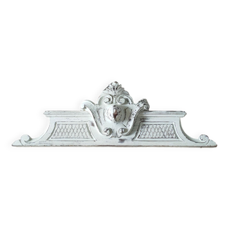 Old pediment in painted wood