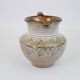 Glazed ceramic jug with plant decoration