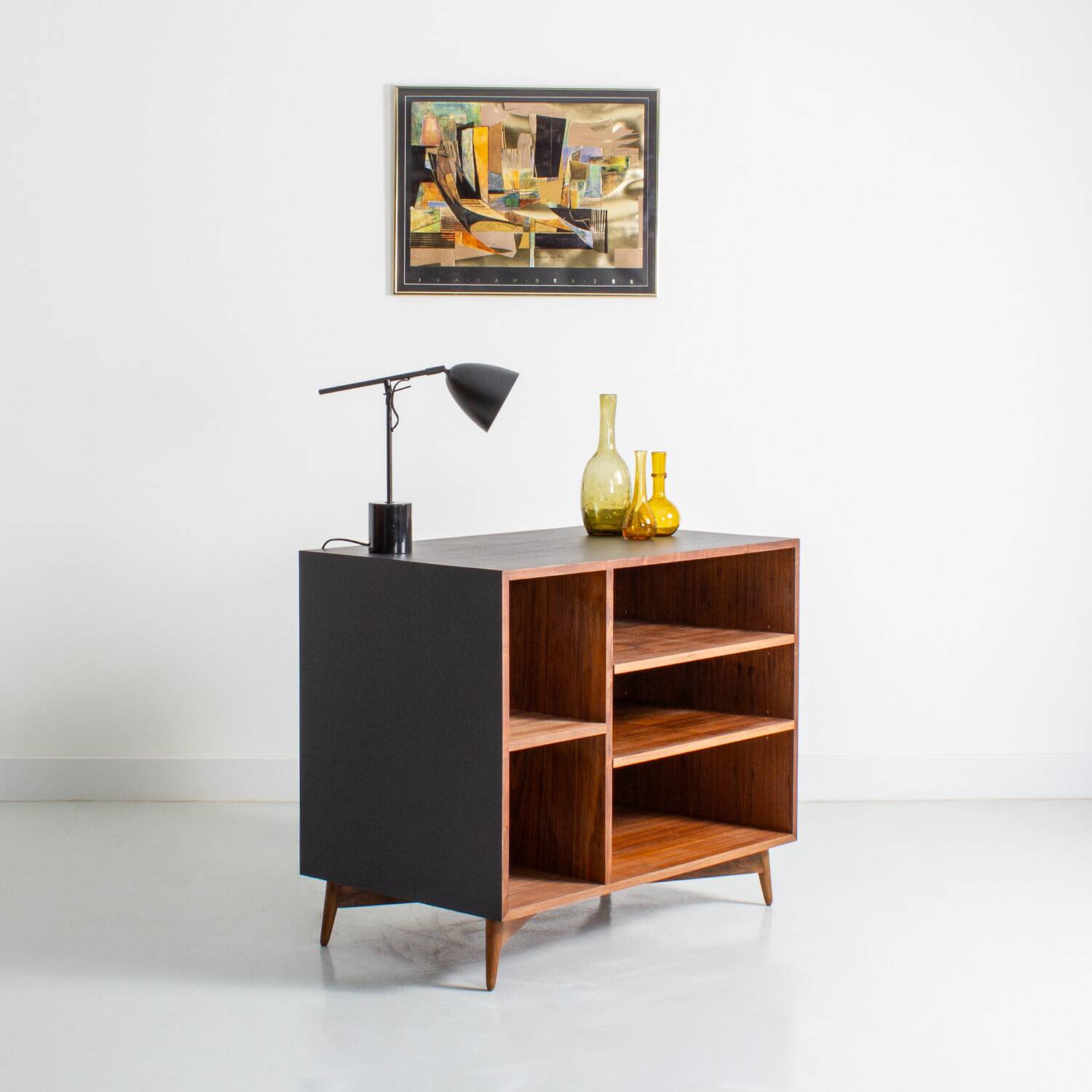 Chest of drawers in walnut and black paint, solid walnut base