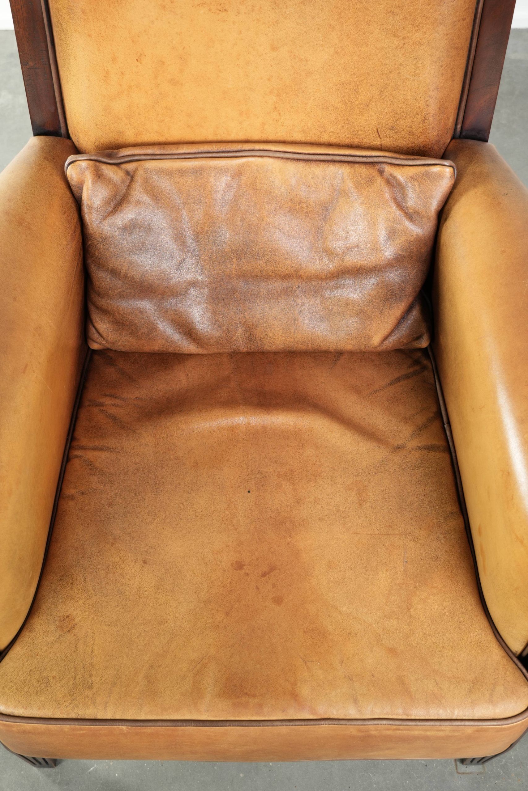 Cognac-coloured Art Deco design armchair made of sheepskin with a high back