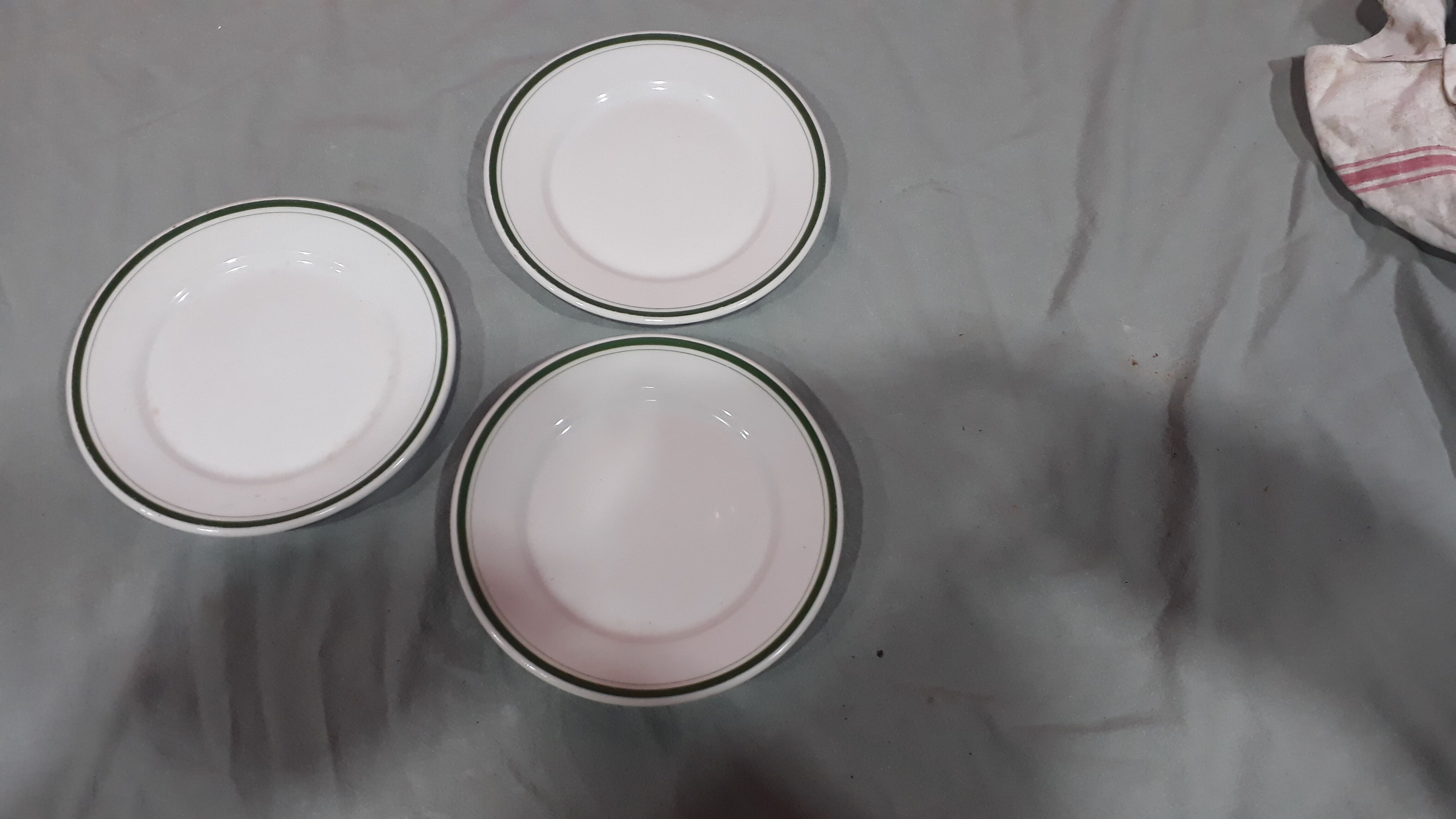 3 plates in white porcelain and green edging