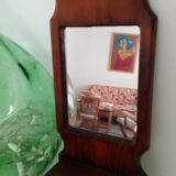 Wooden wall mirror with its shelf