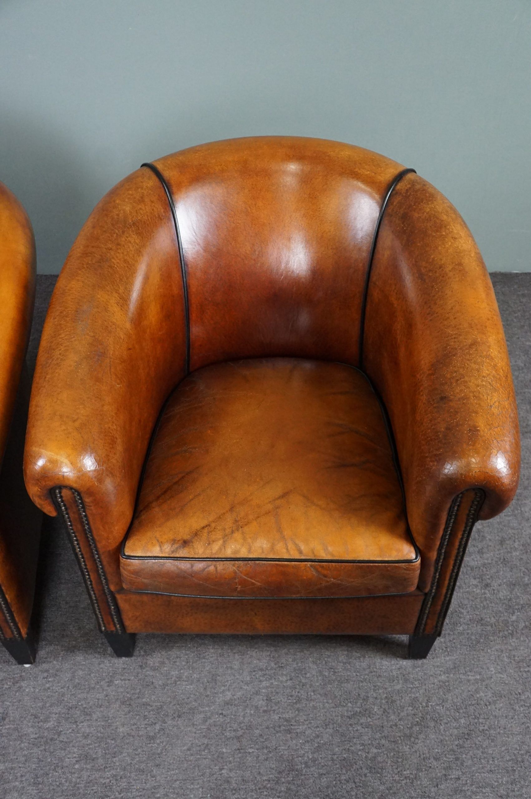 Set of 2 club chairs in black piping sheep leather