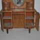 Large vintage brown wooden dressing table with an oval mirror and built-in storage.