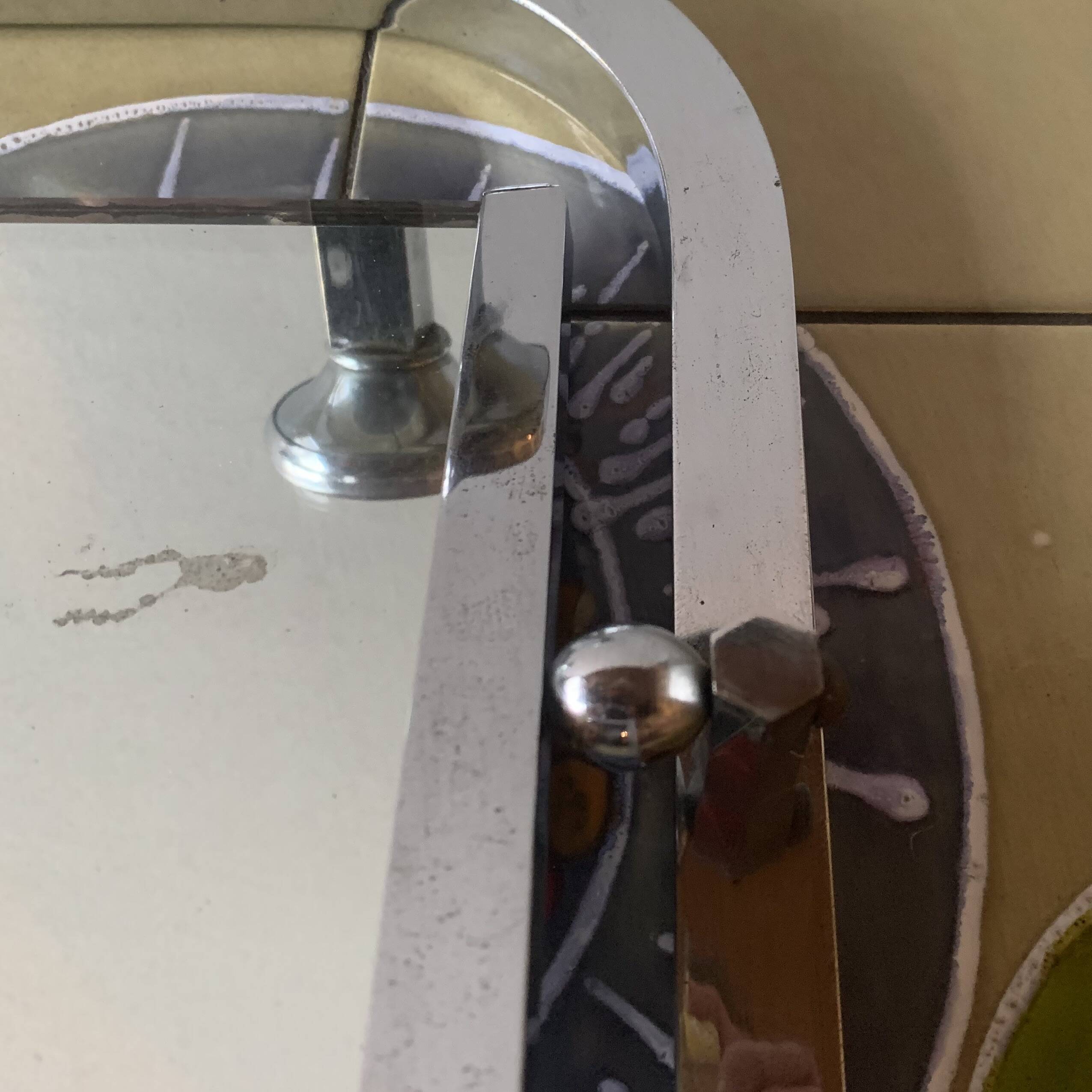 Vintage wall-mounted coat rack in chrome metal with integrated mirror and hat rack