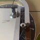 Vintage wall-mounted coat rack in chrome metal with integrated mirror and hat rack