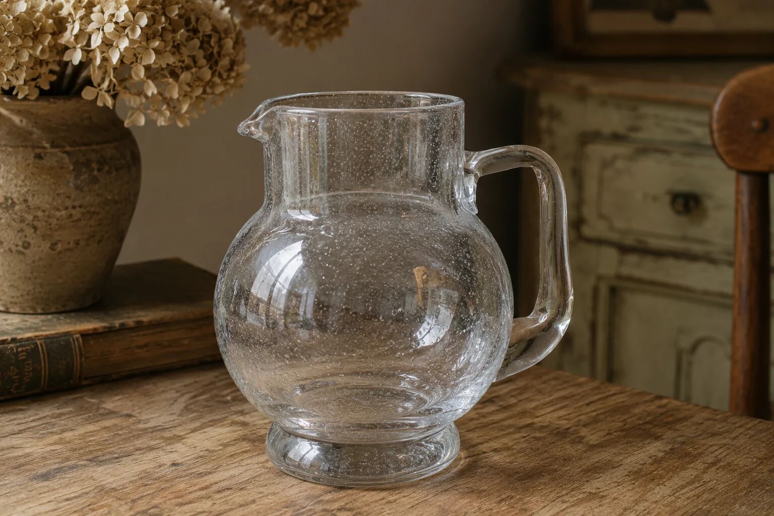 Vintage blown glass pitcher with bubbles, transparent.