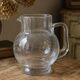 Vintage blown glass pitcher with bubbles, transparent.