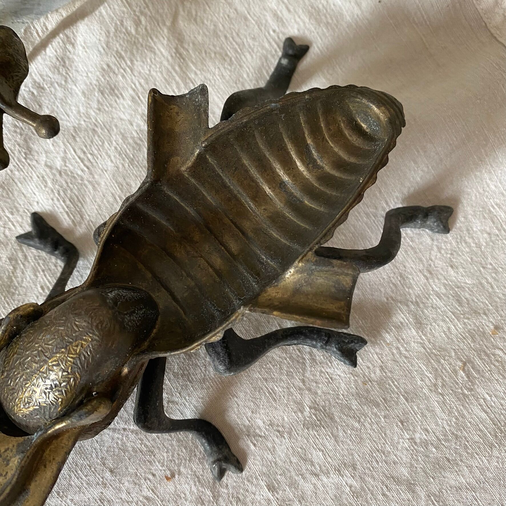 2 metal ashtrays with insect fly designs from the 1950s-60s.