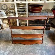 Curved and turned wooden wall shelf
