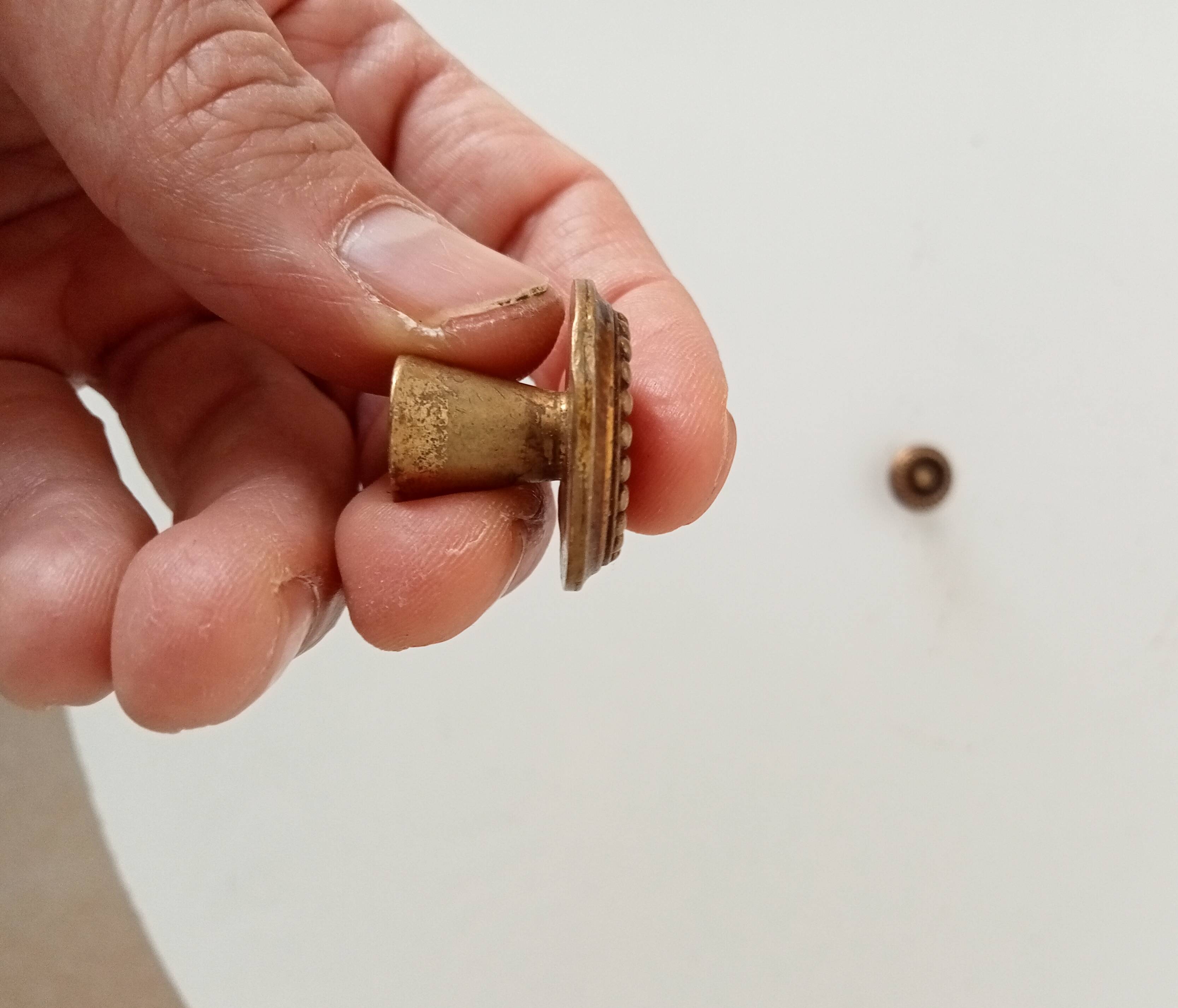 Pair of antique furniture knobs in gilded brass.